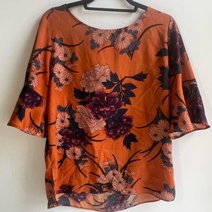 Orange floral blouse.